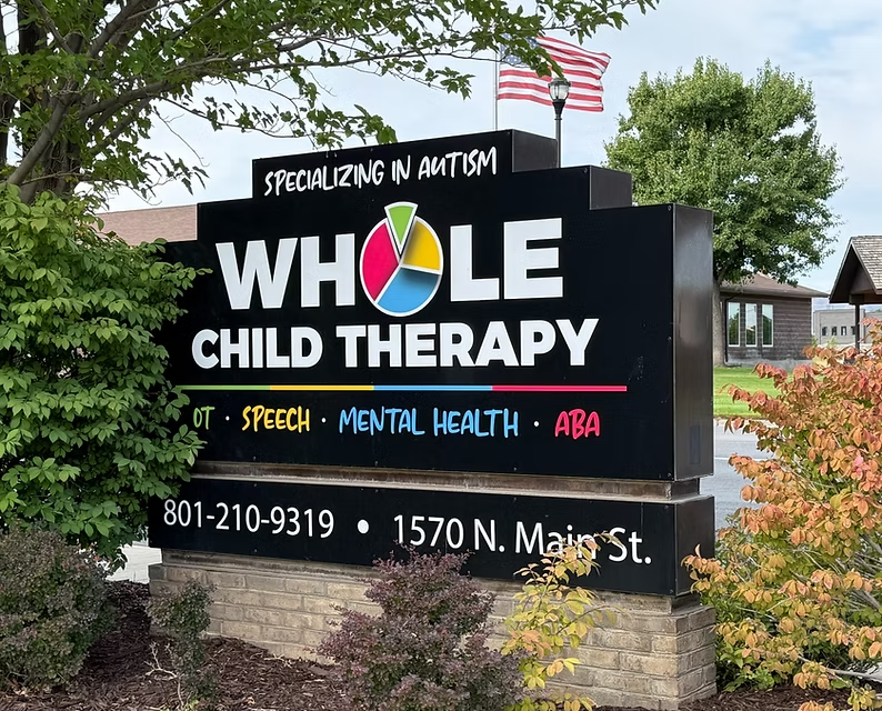 The Whole Child Therapy sign at 1570 N. Main St. in Spanish Fork, reading Specializing in Autism with OT, Speech, Mental Health and ABA